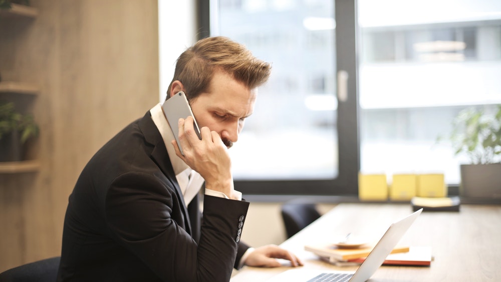 Pictured: businessman talking on smart phone