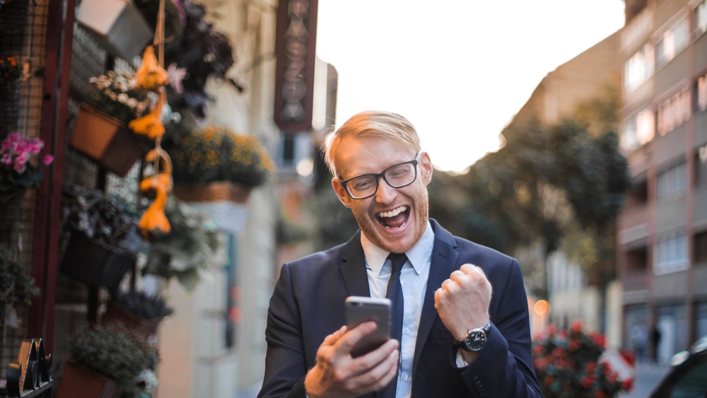 Happy businessman walking down the street.