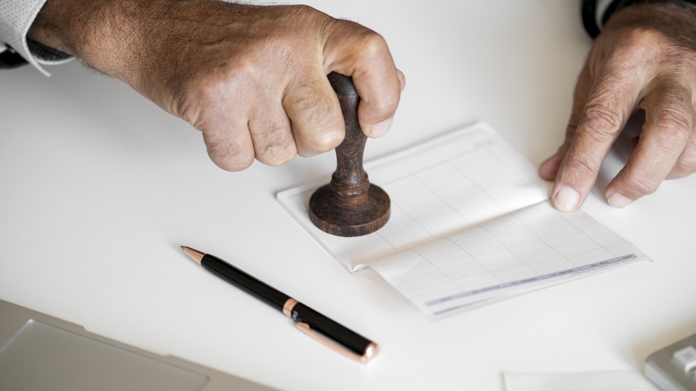 Picture of a person stamping a document