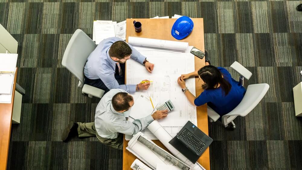 Picture of a busy-looking team sitting on a table.