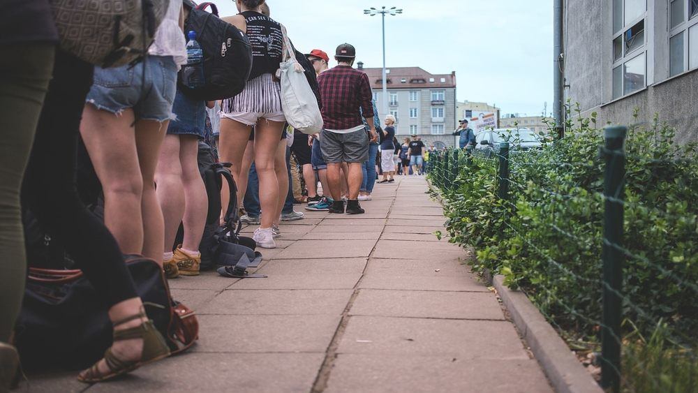 People waiting in line on street