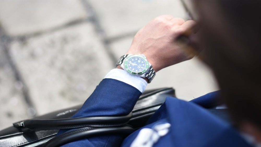 Businessman looking down at his wrist watch