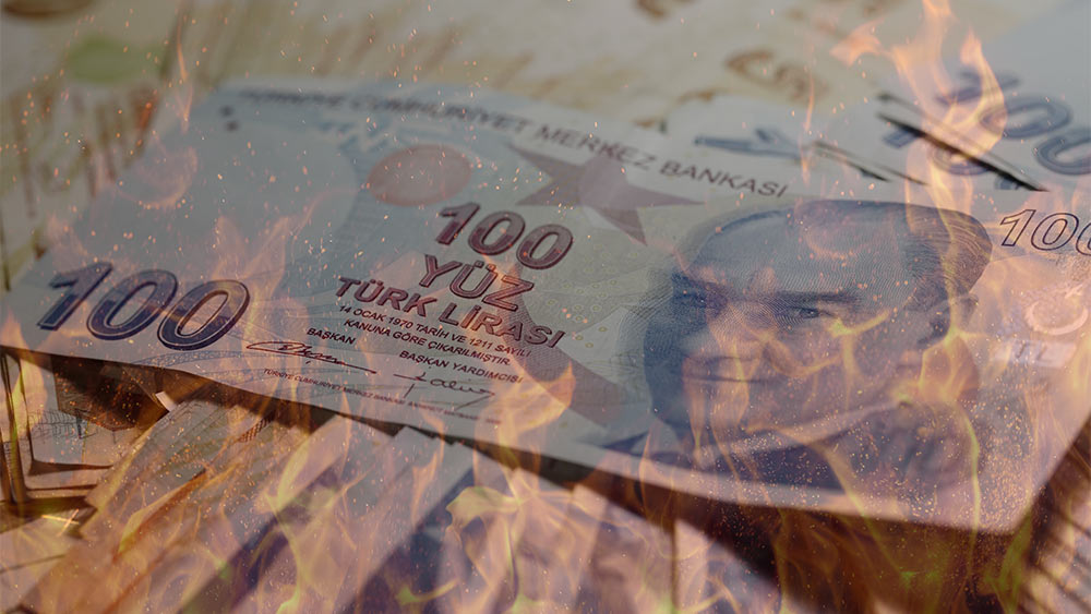 Turkish lira banknote in flames