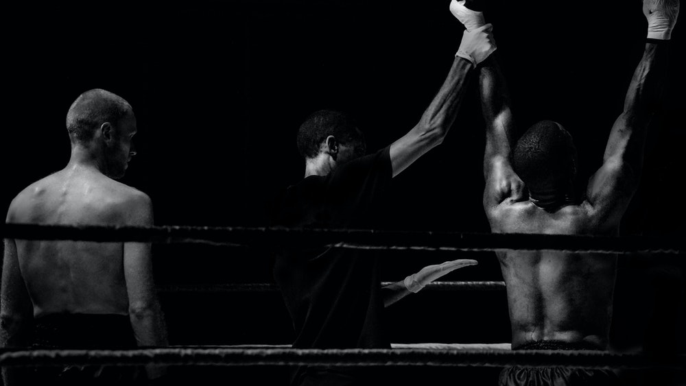 Black and white picture of boxing ring players