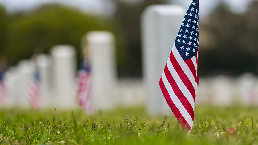 Picture of a U.S. flag honoring Memorial Day on tombstone background 